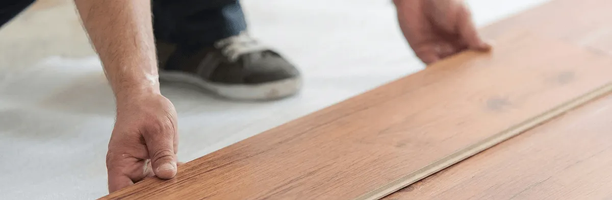 A professional installing laminate flooring in Mesa, AZ